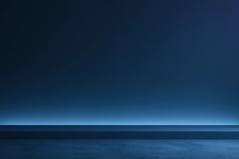 Dark navy blue seamless studio backdrop with flat matte wall and horizontal horizon line