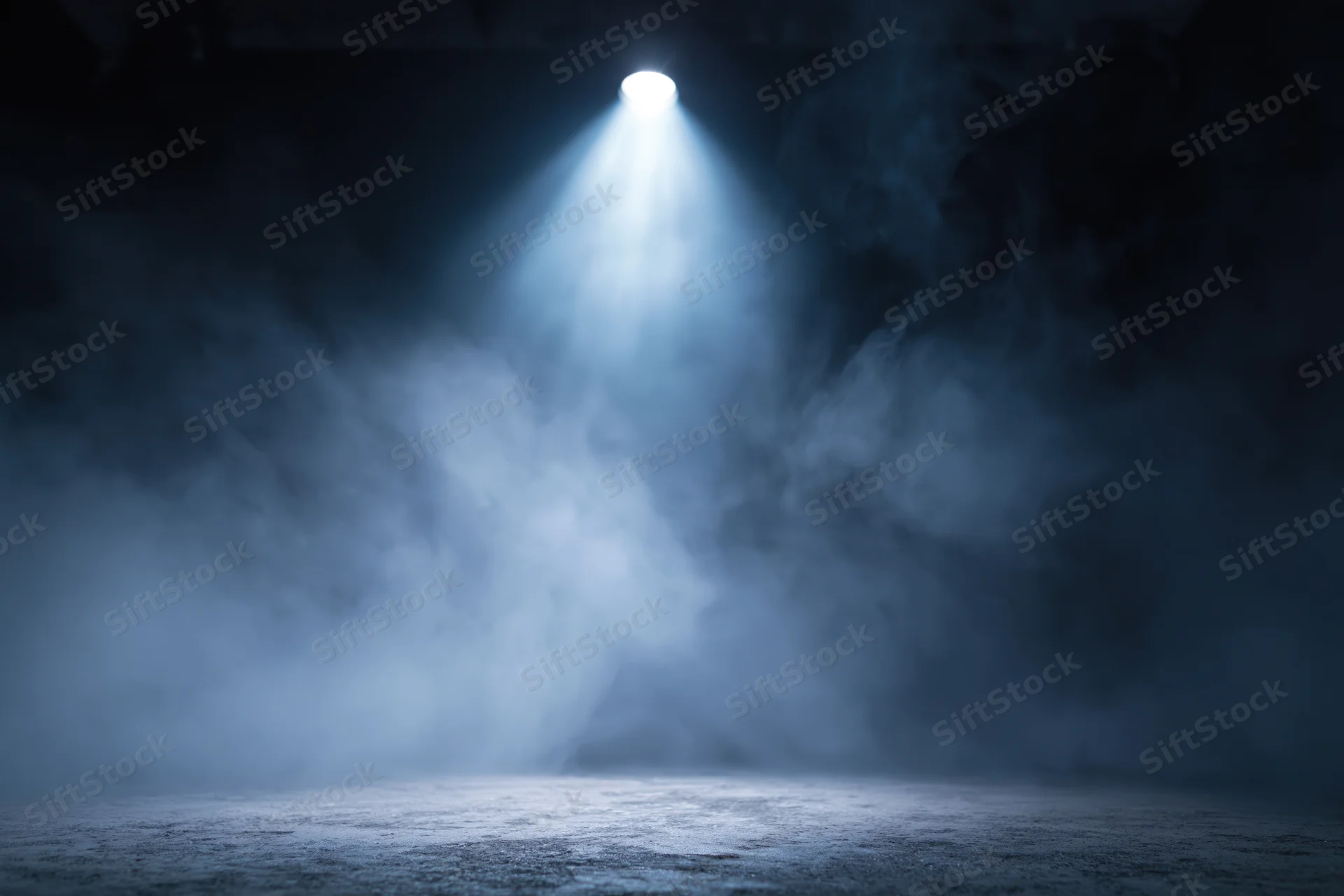 Single spotlight beam cutting through smoke on an empty dark stage floor