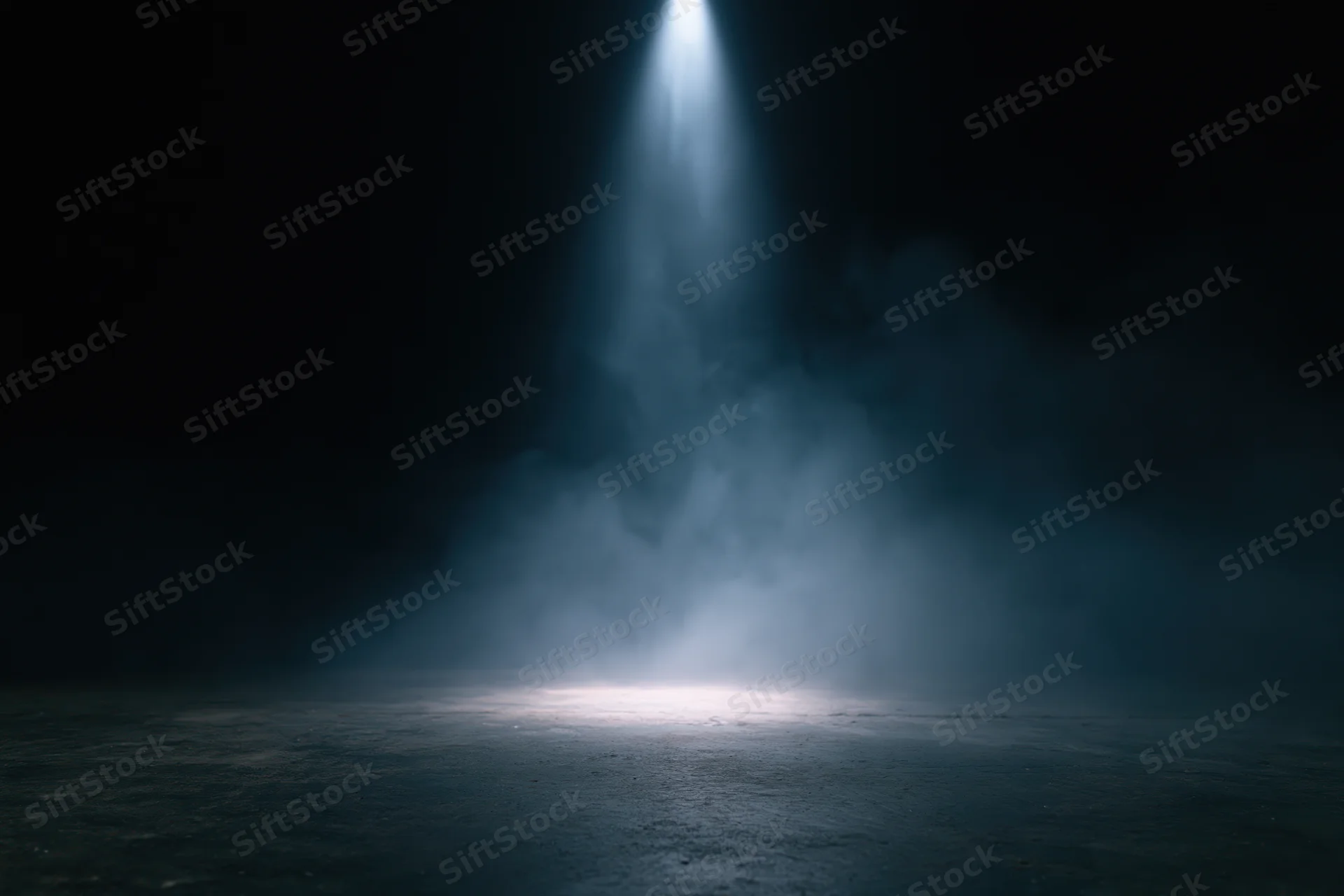 Single spotlight beam illuminating a smoky dark stage floor