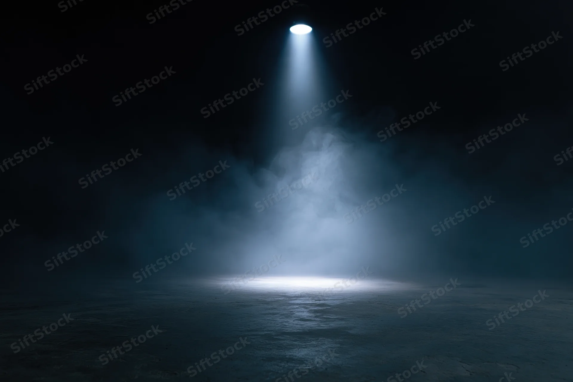 Single spotlight illuminating a smoky dark stage floor