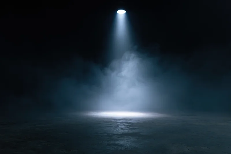 Single spotlight illuminating a smoky dark stage floor