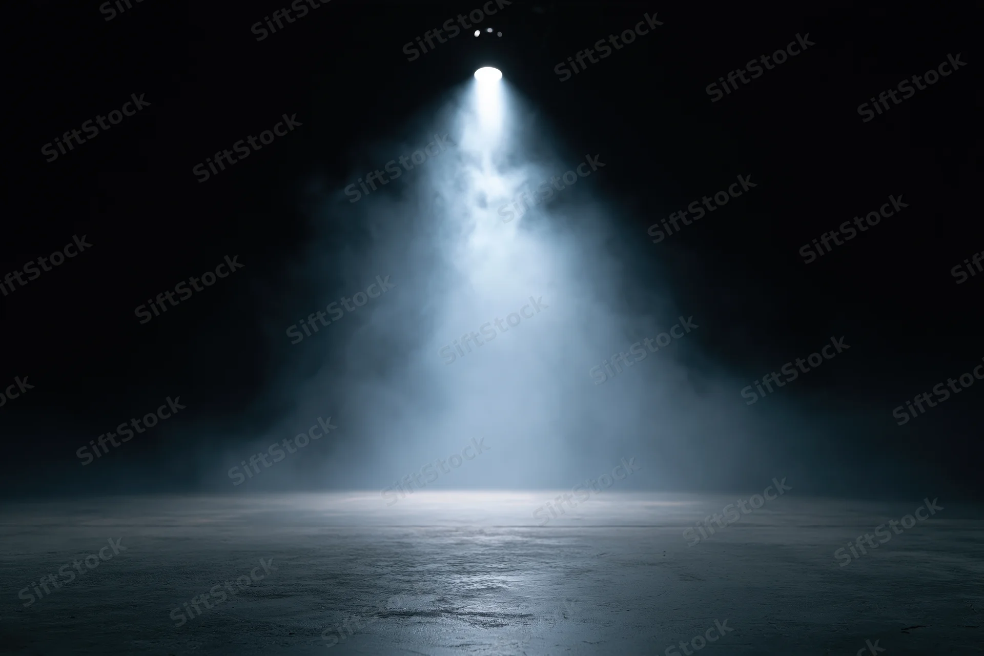 Single spotlight illuminating a smoky dark stage floor