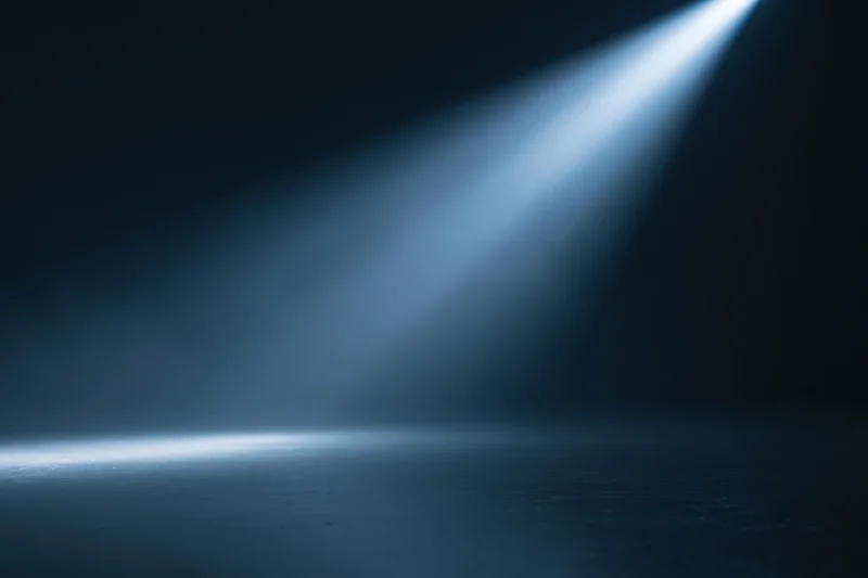 Diagonal spotlight beam in dark studio space