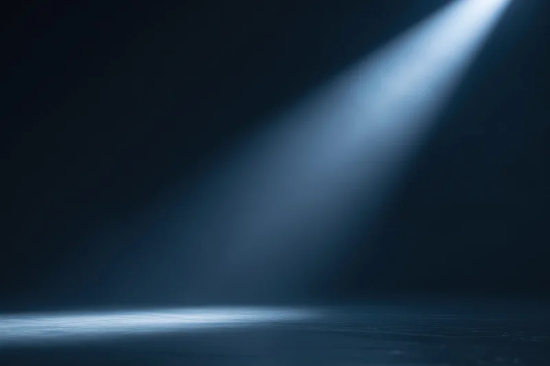 Diagonal spotlight beam in dark studio space