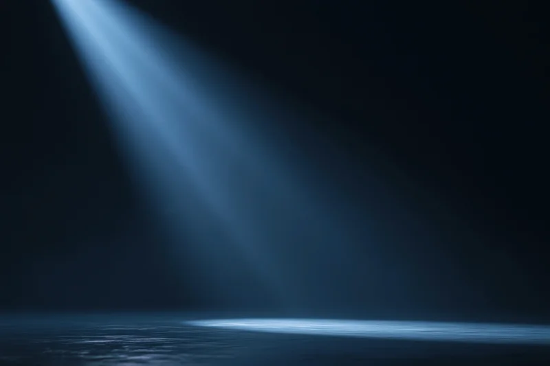 Diagonal spotlight beam illuminating dark studio floor