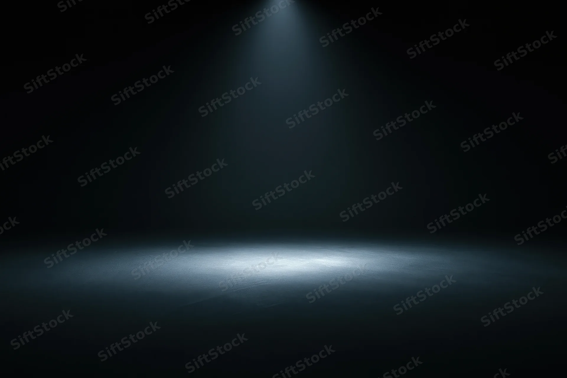 Single spotlight illuminating a dark studio floor