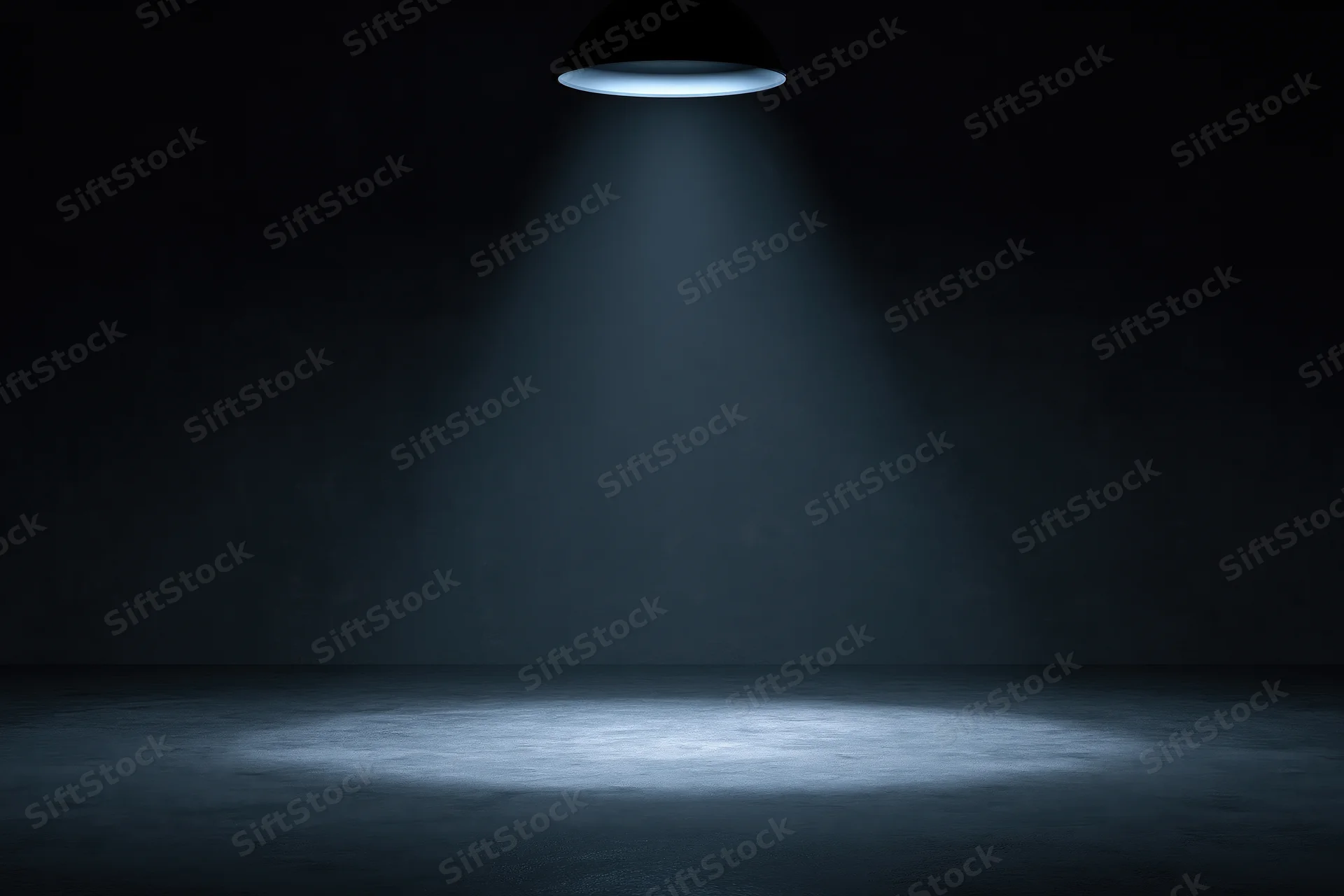 Single overhead spotlight casting a blue beam on an empty dark studio floor