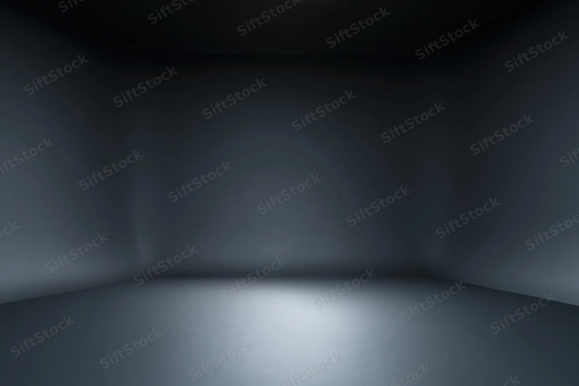 Dark empty studio interior with seamless floor and walls, spotlight on floor creating gradient shadow