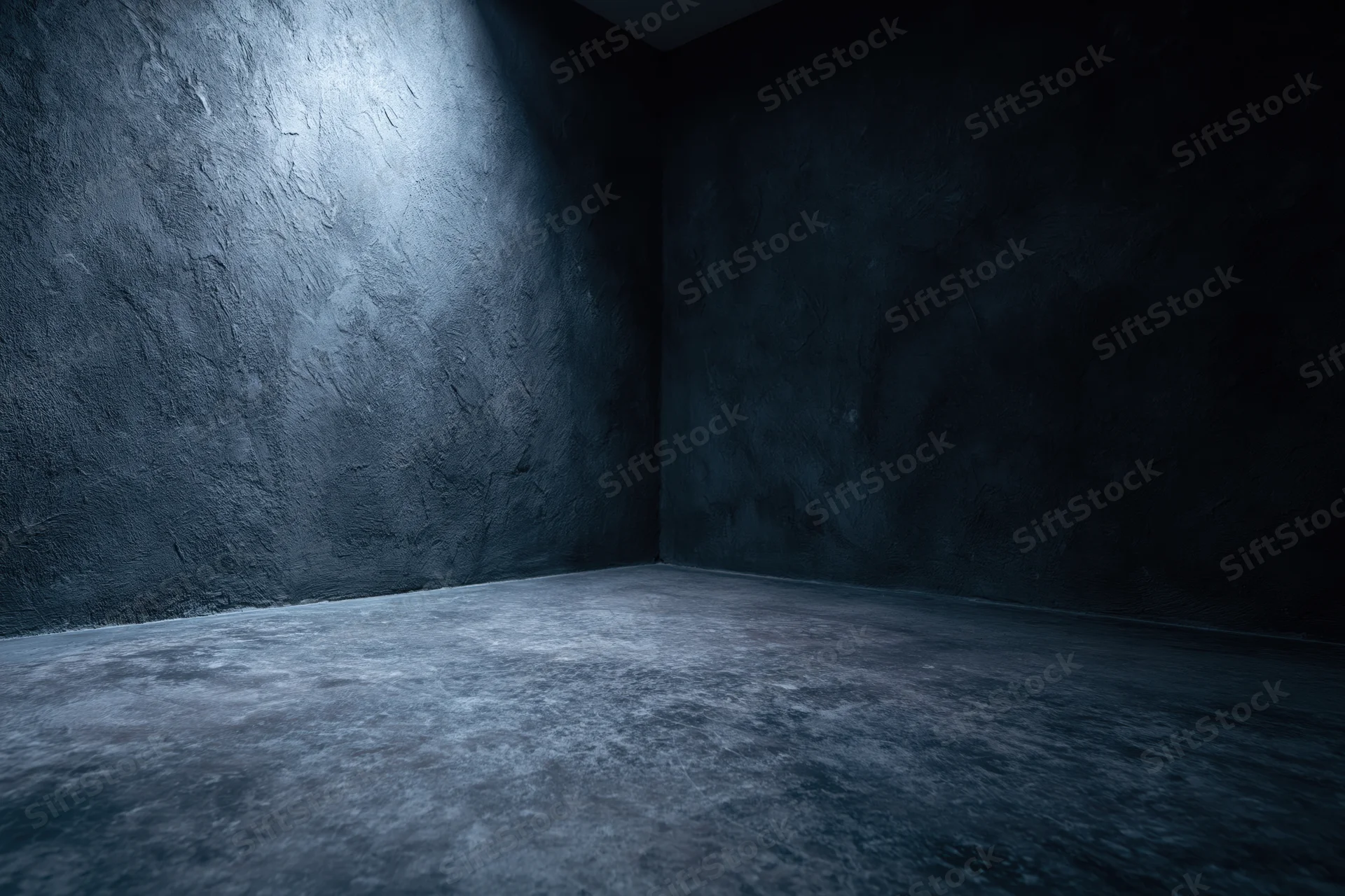 Dark textured concrete corner in empty studio space with spotlight and shadow