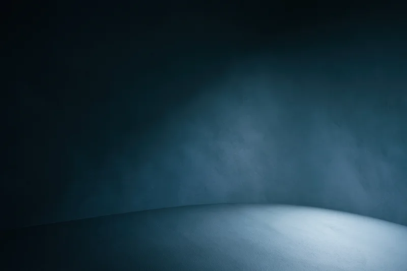 Curved seamless backdrop in a photography studio with spotlight and shadow