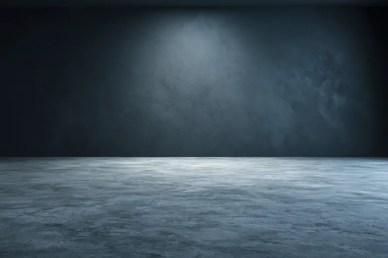 Empty concrete room interior with spotlight on dark textured wall and floor