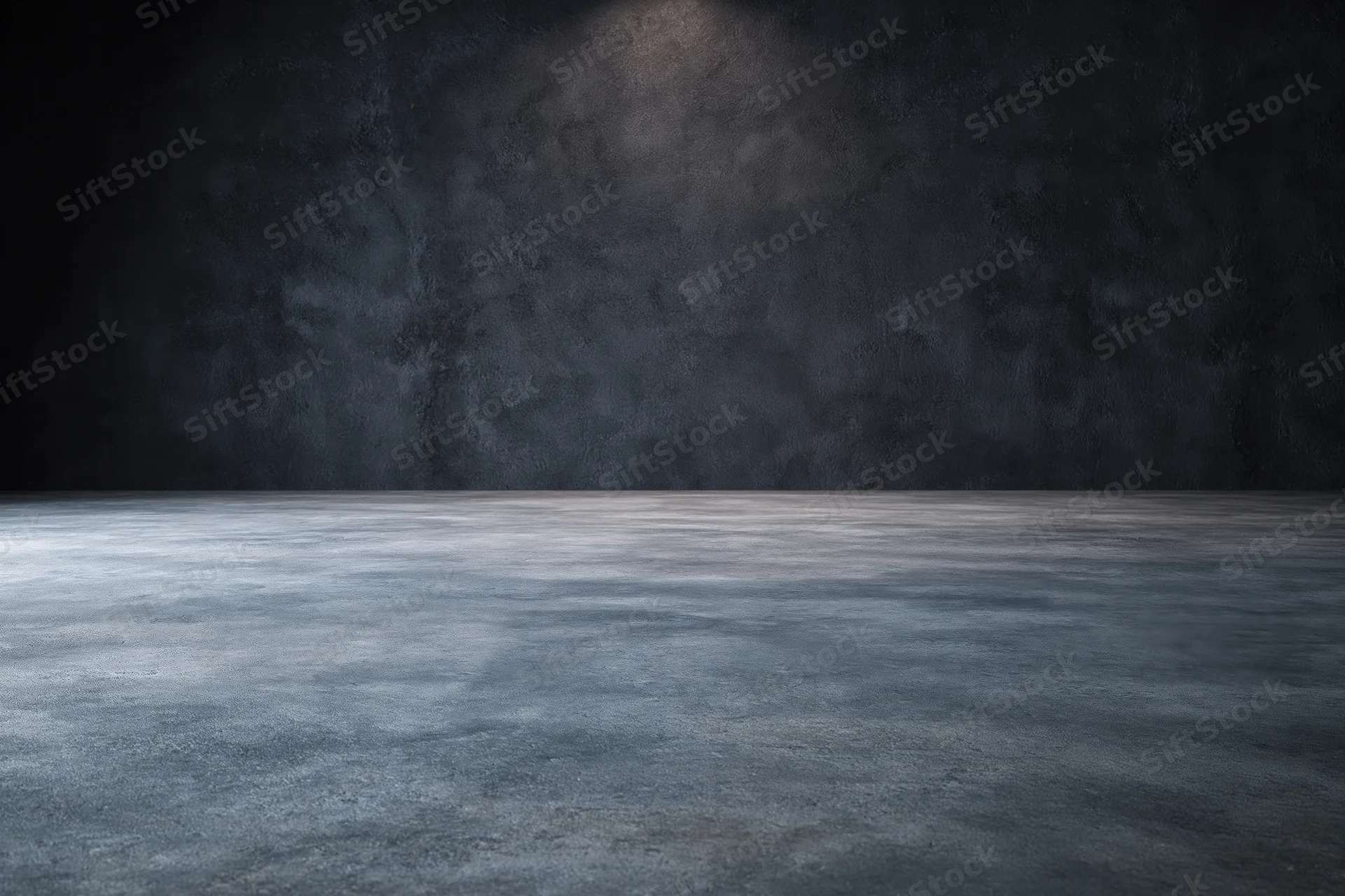 Empty industrial room with concrete floor and dark textured wall under spotlight
