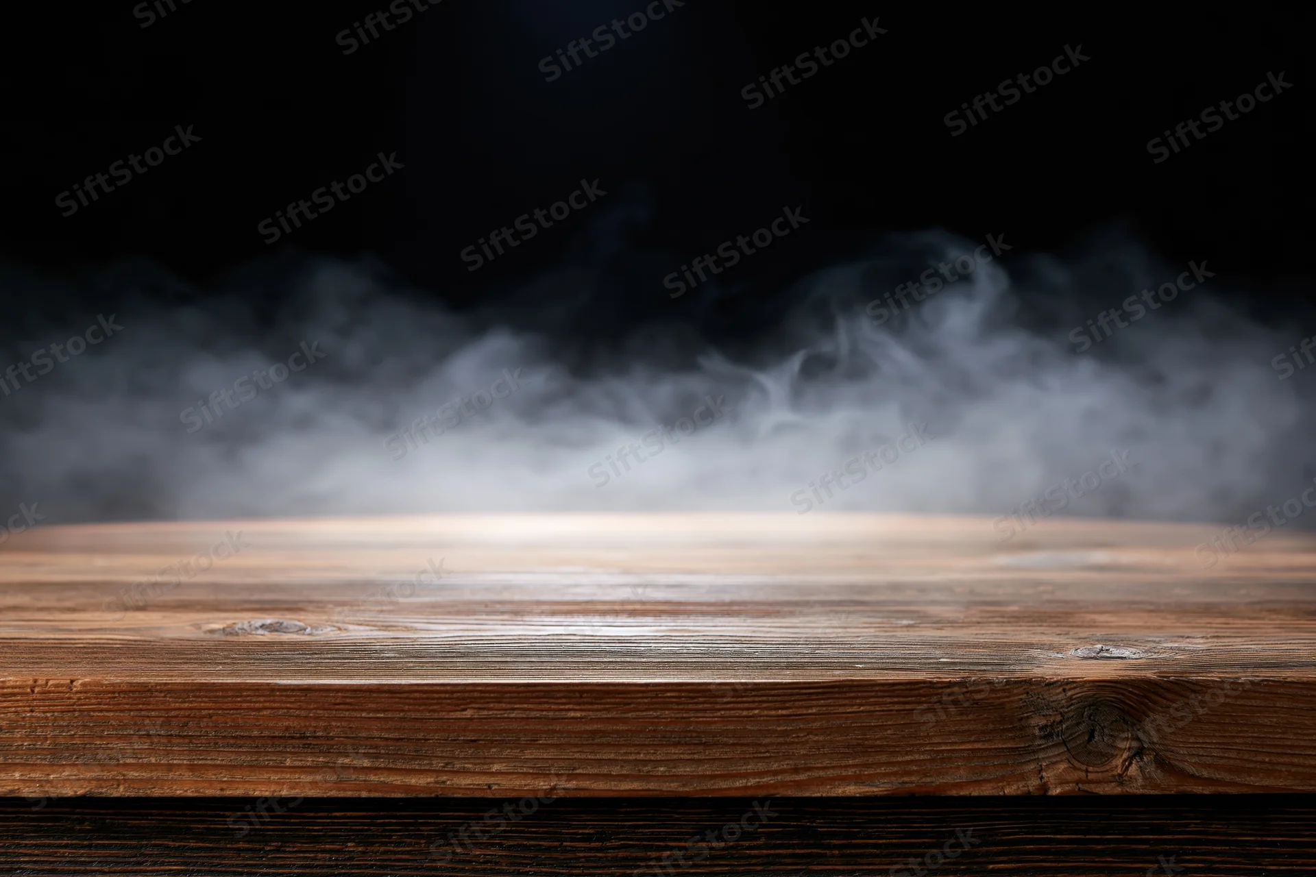 Rustic wooden tabletop with wispy smoke in dark background
