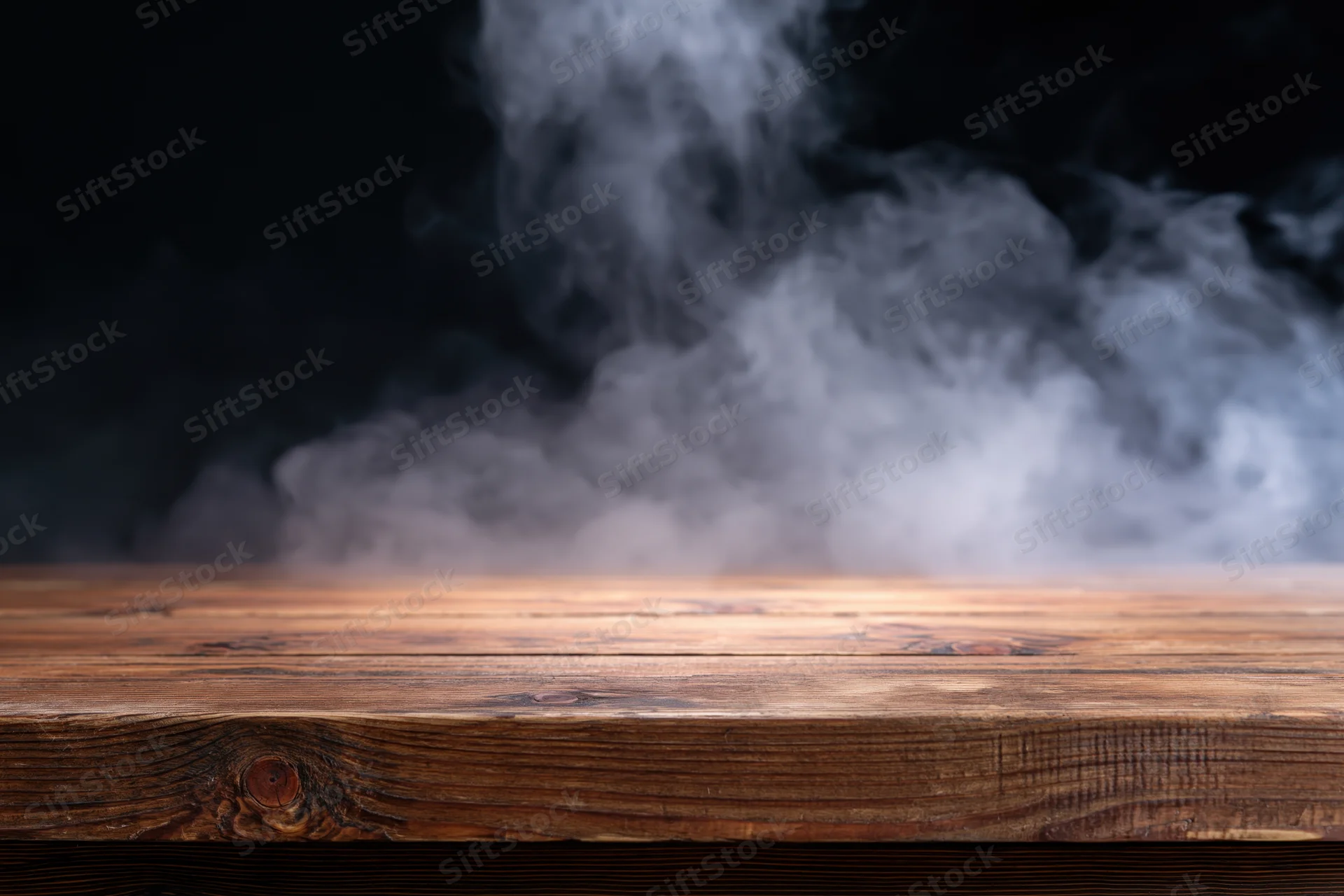 Rustic wooden tabletop with rising smoke against dark background, copyspace for product display
