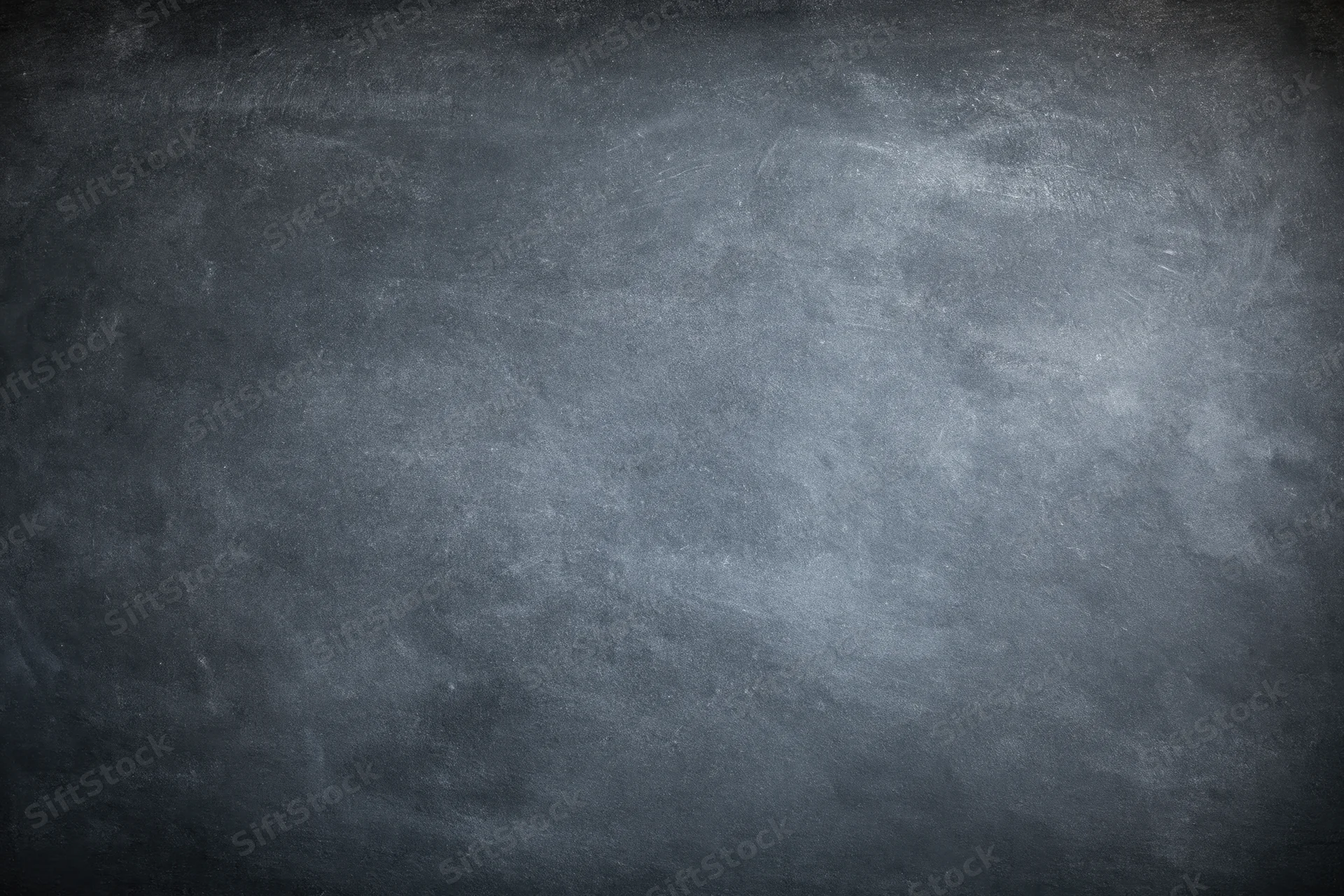 Dark grey concrete wall surface with rough texture and vignette lighting