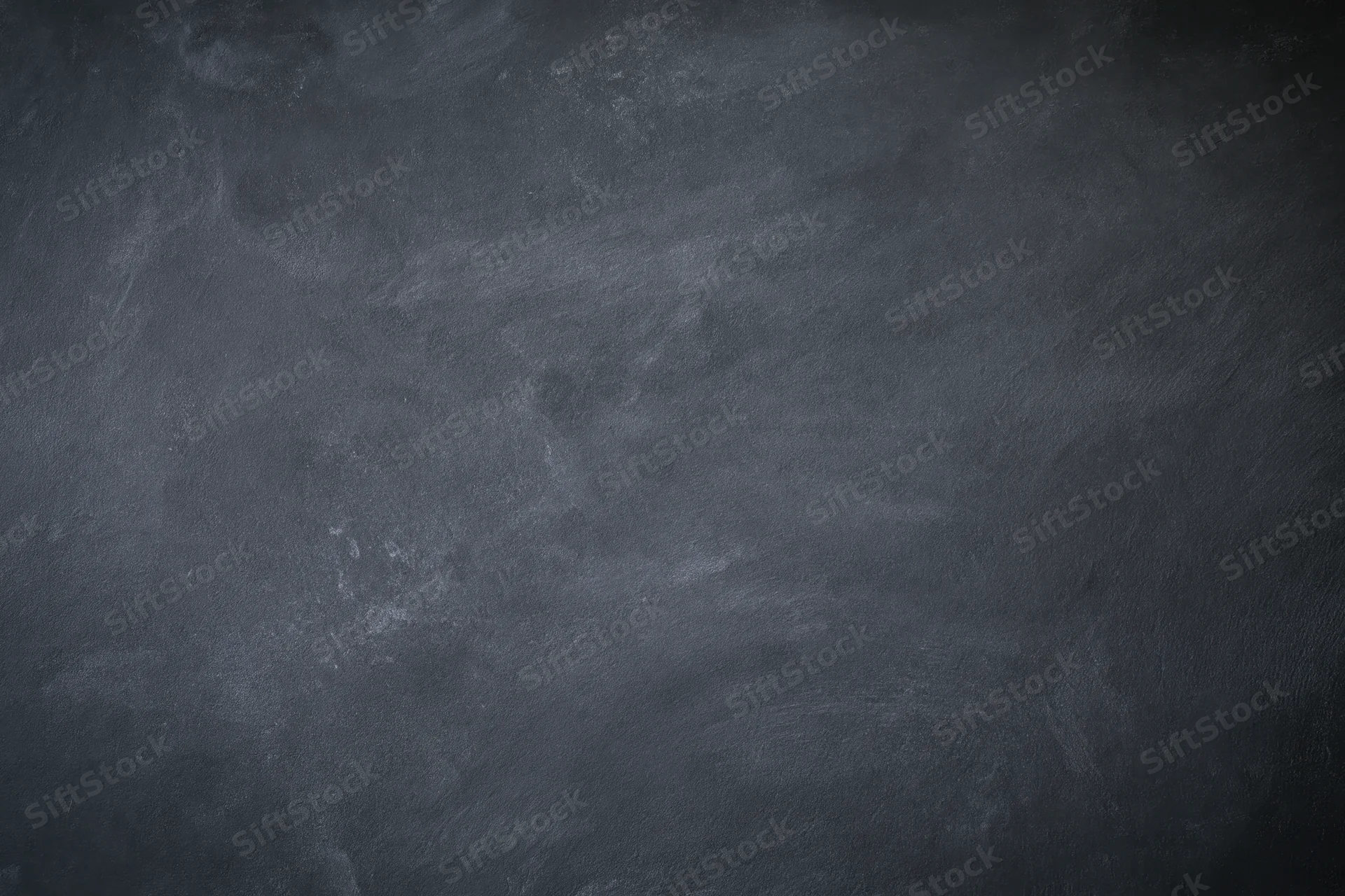 Dark grey concrete wall surface with rough texture filling the frame