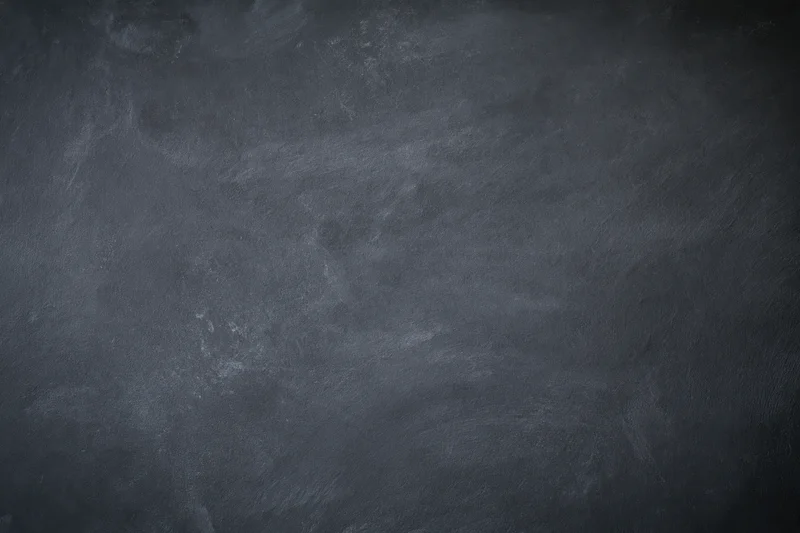 Dark grey concrete wall surface with rough texture filling the frame