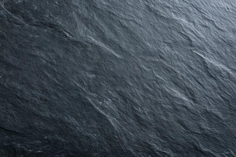 Close-up of dark slate stone surface with natural texture and veining