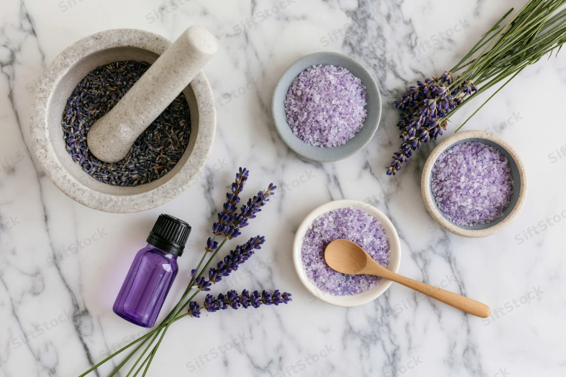 Lavender spa products arranged on white marble surface in flat lay overhead view