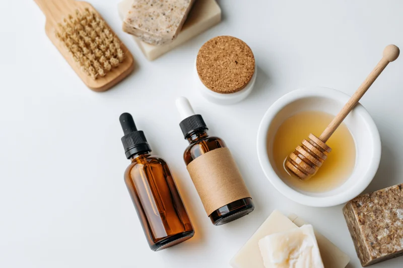 Natural skincare products arranged in flat lay on white background
