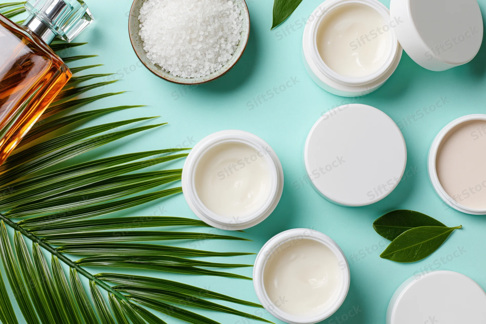 Skincare products and natural elements arranged in a flat lay on a light blue surface