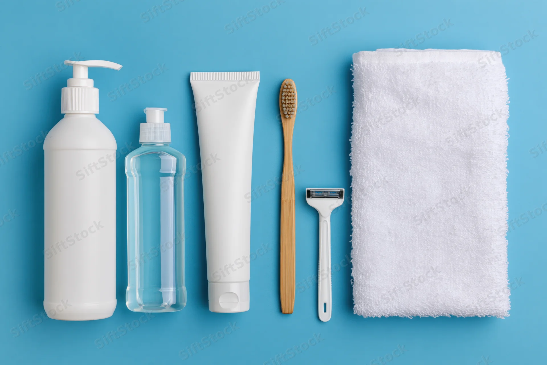 Personal care products arranged in a flat lay on a blue background