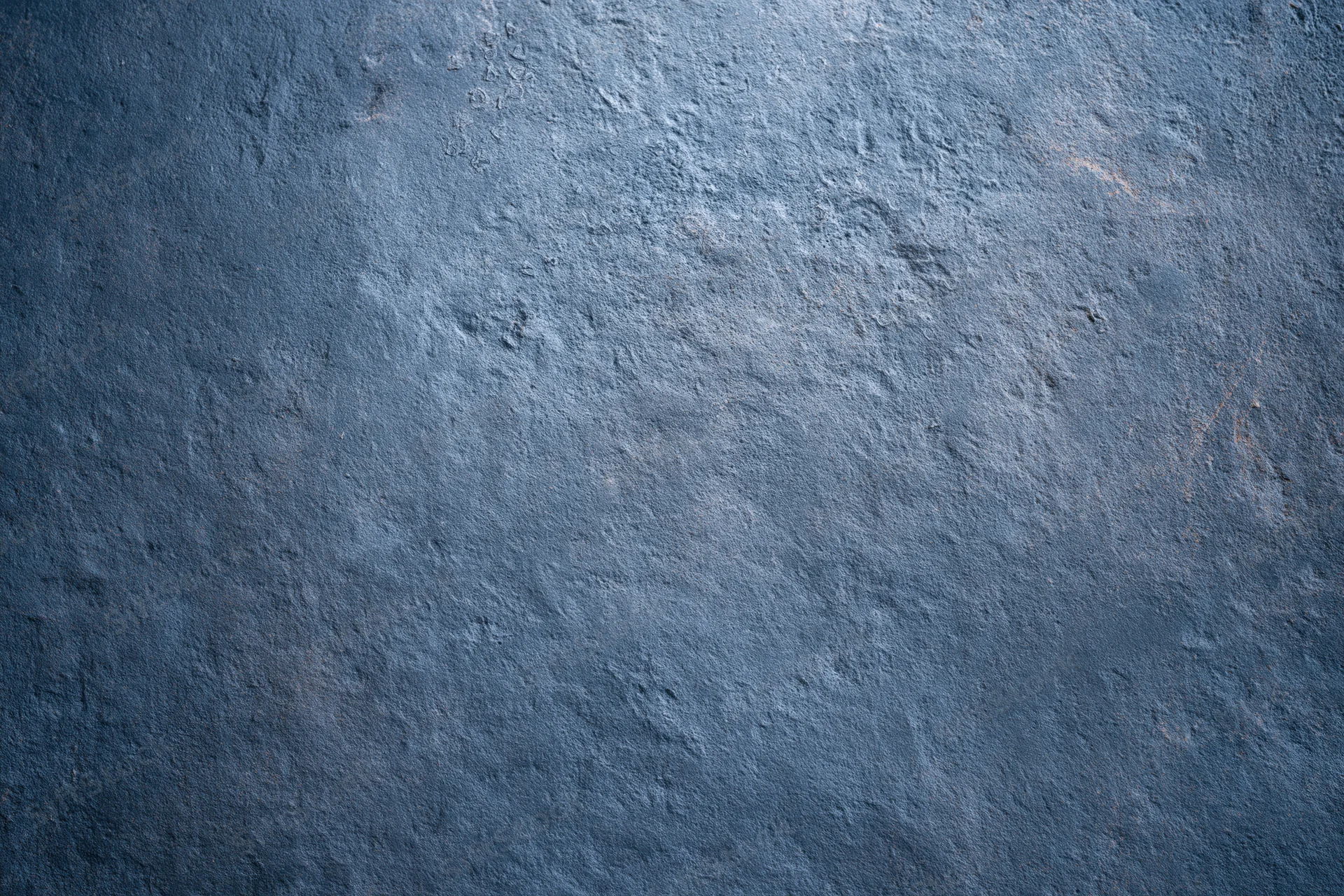 Textured concrete wall surface with rough gray-blue finish filling the frame