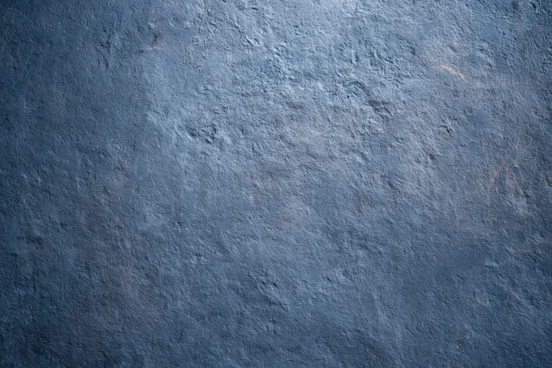 Textured concrete wall surface with rough gray-blue finish filling the frame