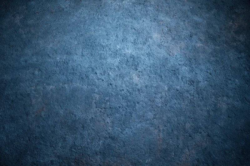 Textured blue concrete wall surface with rough industrial finish