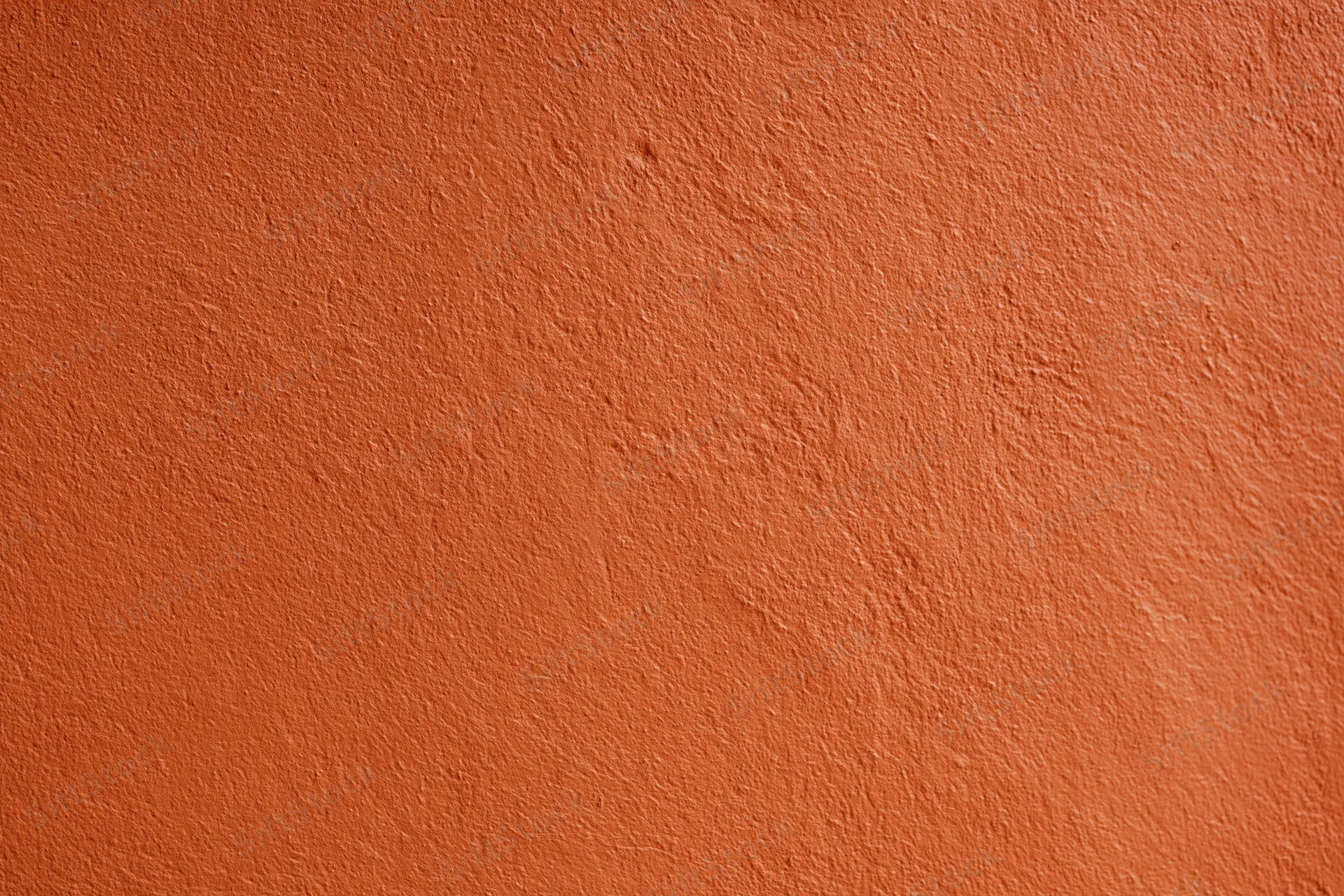 Textured orange stucco wall surface filling the frame