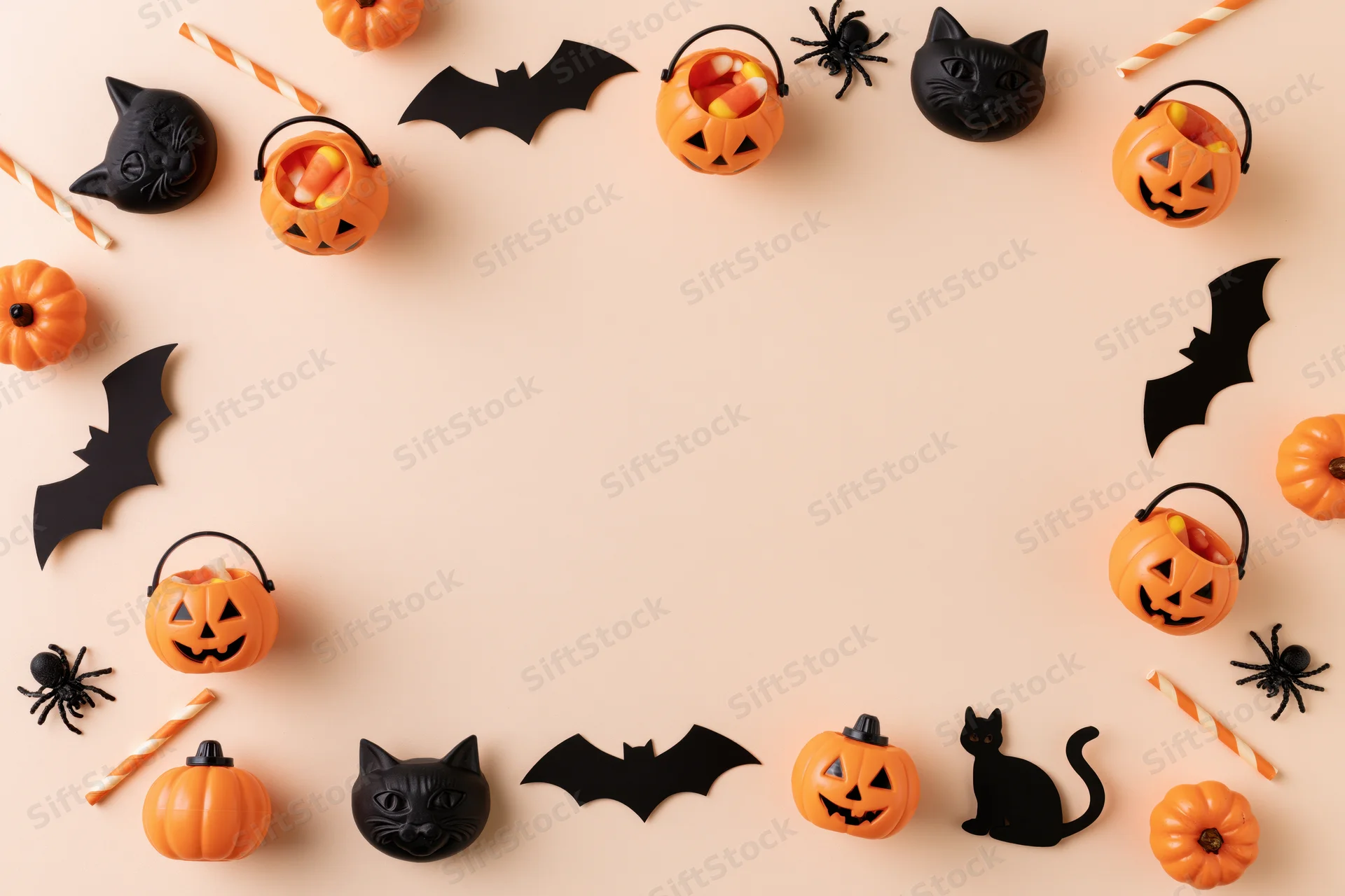 Halloween decorations arranged in a circular frame on a flat surface with copyspace in the center