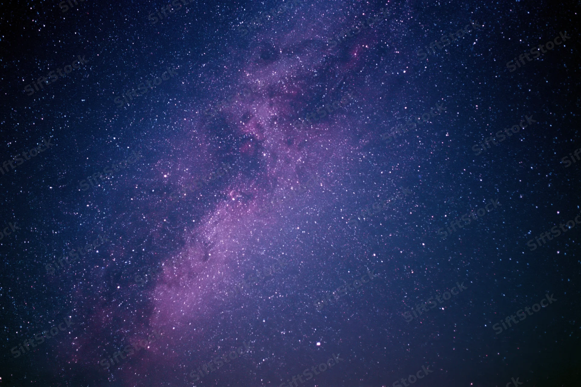 Night sky filled with scattered stars and a dense milky way band