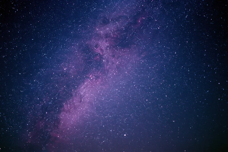 Night sky filled with scattered stars and a dense milky way band