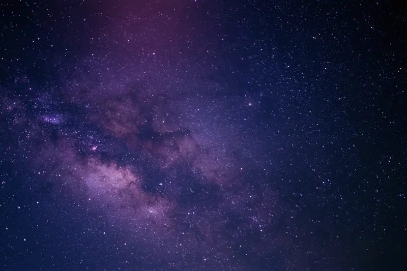 Night sky filled with scattered stars and dense milky way band