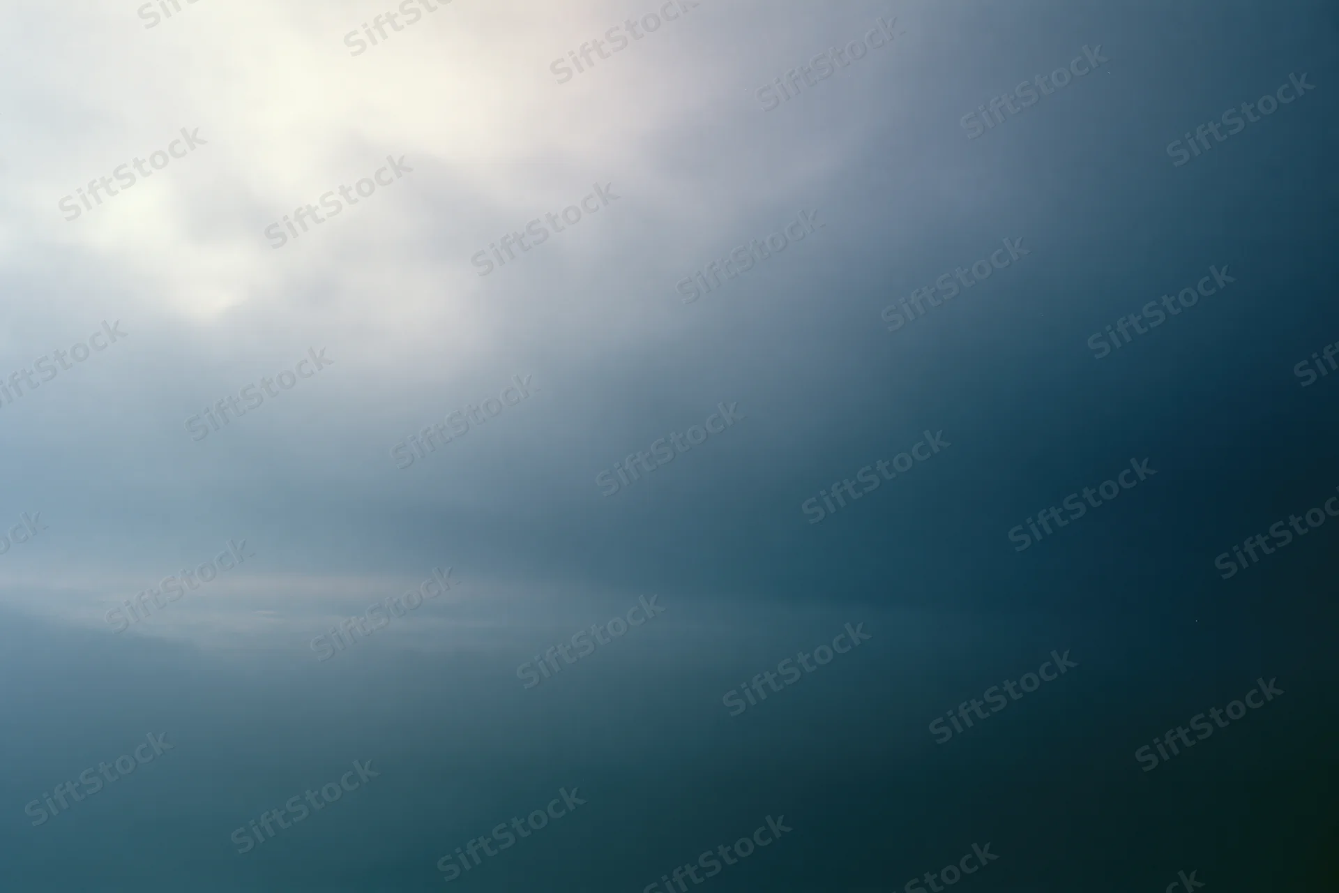 Overcast sky at dusk with soft diffused light and layered clouds filling the frame