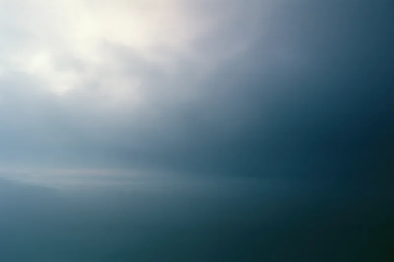 Overcast sky at dusk with soft diffused light and layered clouds filling the frame