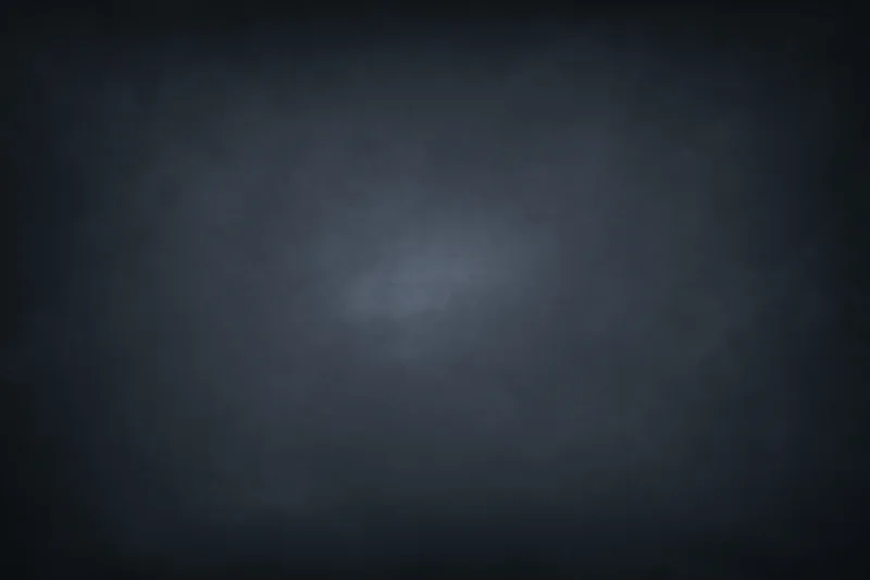 Dark charcoal studio backdrop with subtle centered spotlight gradient