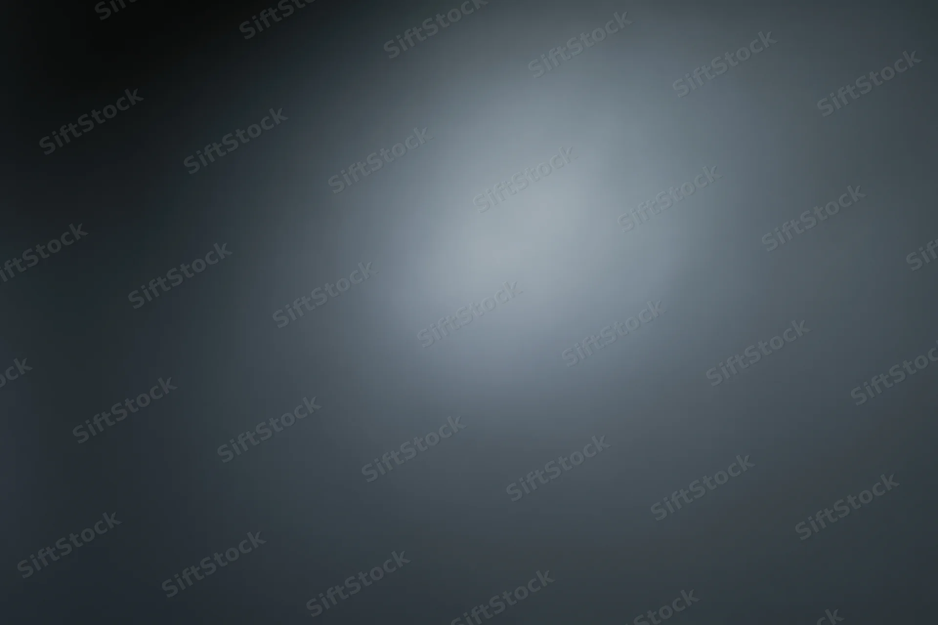 Smooth dark grey gradient background with soft light centered and subtle vignette effect