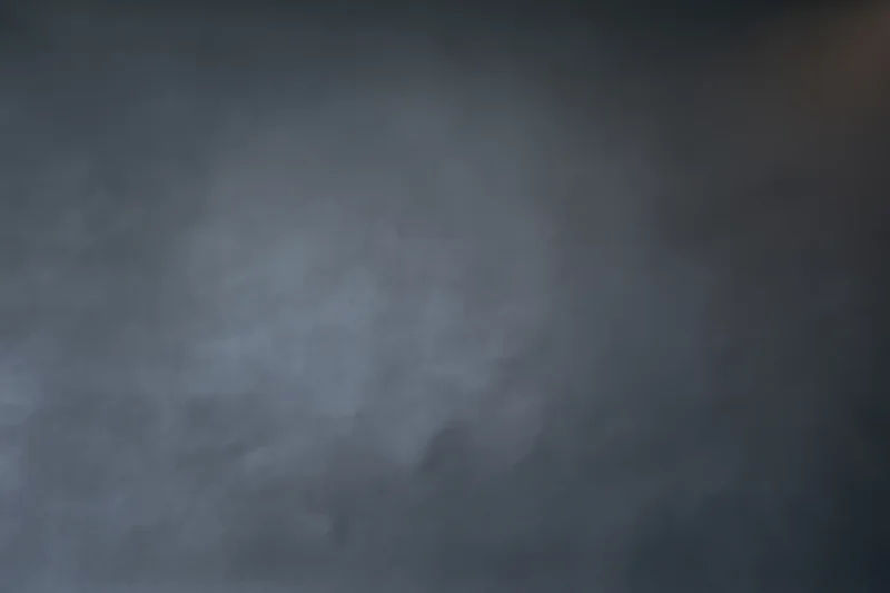 Dark grey gradient background with smooth matte texture and soft diffuse lighting