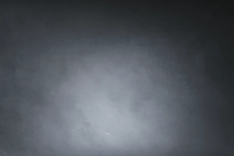 Dark grey gradient background with smooth matte texture and soft light variation
