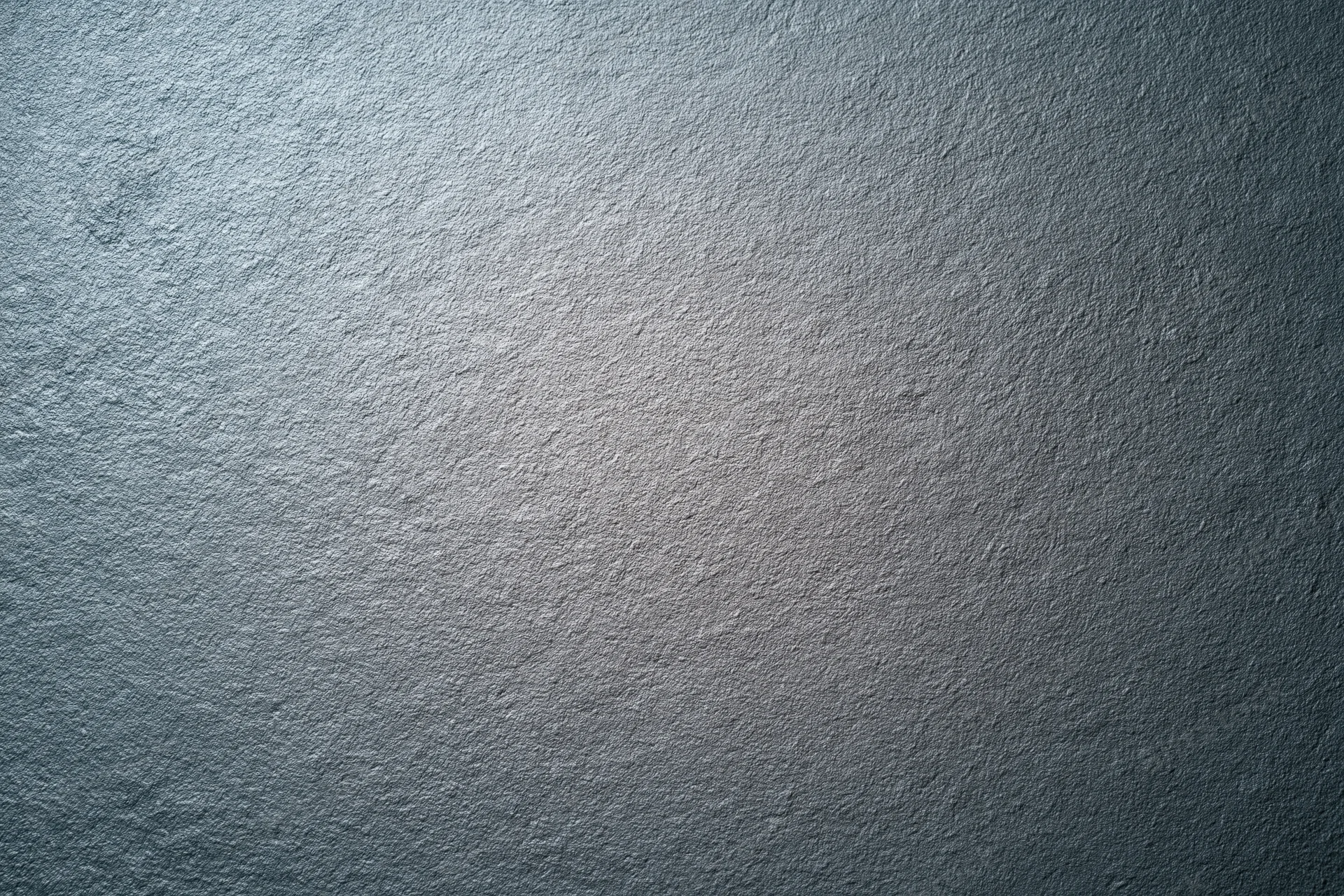 Textured grey matte surface filling the frame as a background