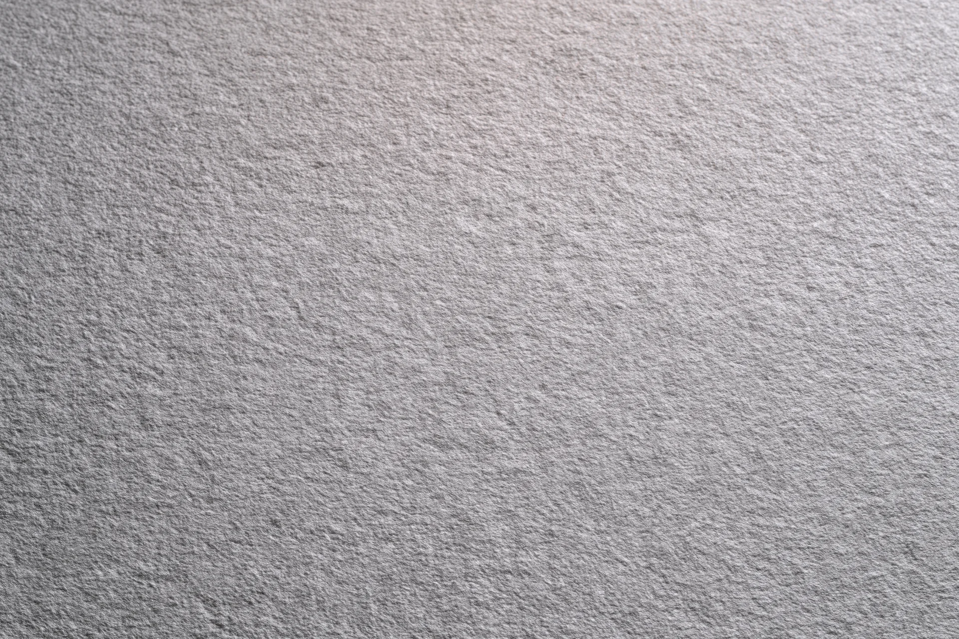 Plain matte grey textured surface filling the frame