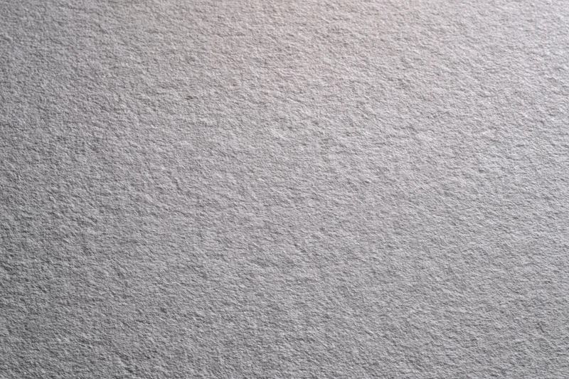 Plain matte grey textured surface filling the frame