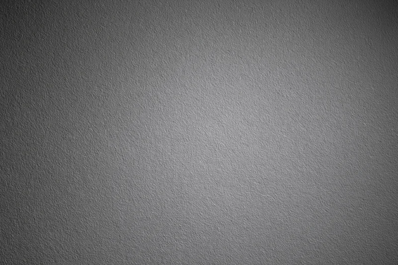 Plain matte grey textured surface filling the entire frame