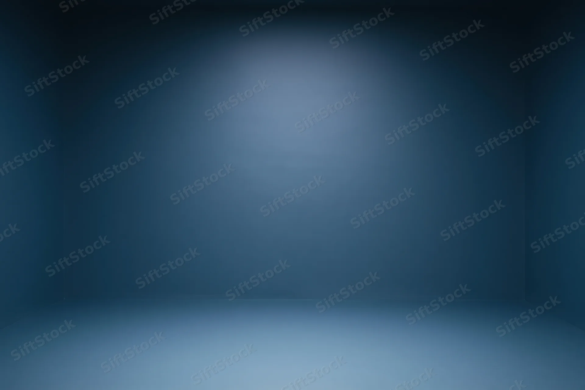 Empty room with smooth navy blue gradient walls and spotlighted center