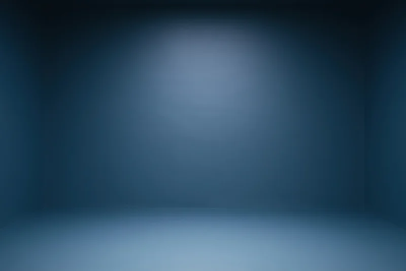 Empty room with smooth navy blue gradient walls and spotlighted center