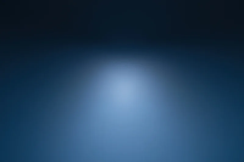 Smooth gradient blue background with soft light centered in frame