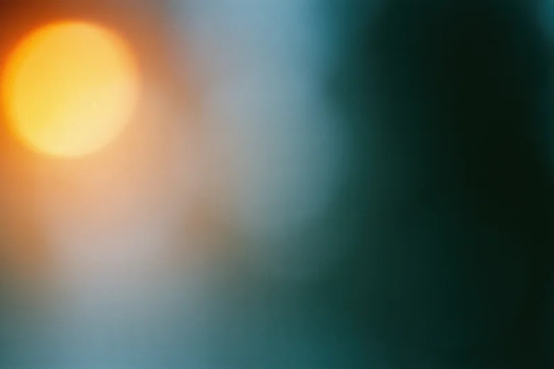 Soft out-of-focus abstract background with warm amber-orange glow and cool teal gradient