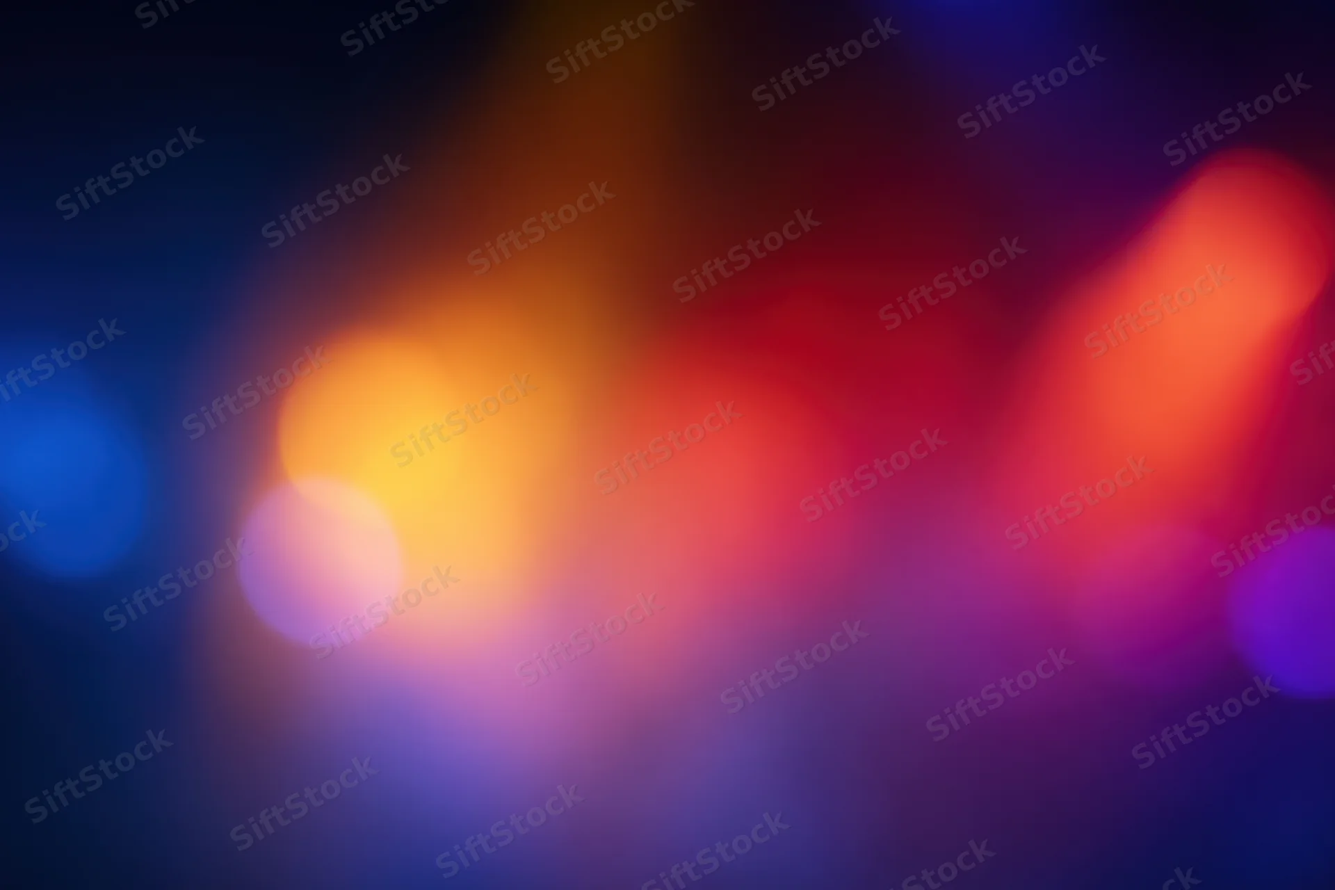 Soft out-of-focus bokeh lights blending in warm and cool tones across a dark background