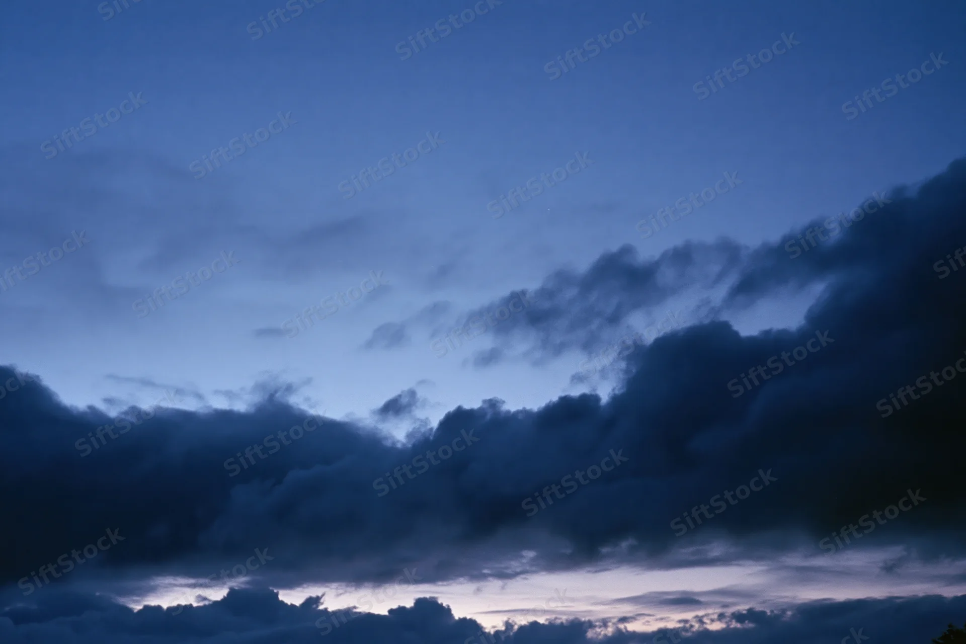 Twilight sky with dark storm clouds after sunset